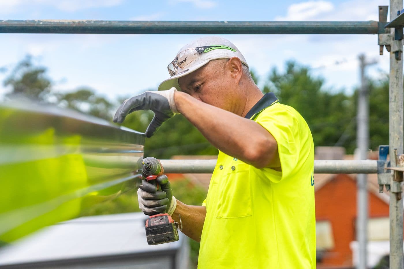 A Leaky Roof roofer fixing a new gutter from the scaffold