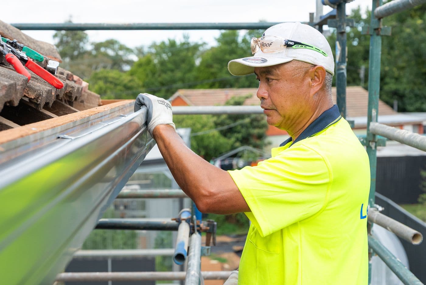 Fitting a new metal gutter along the fascia