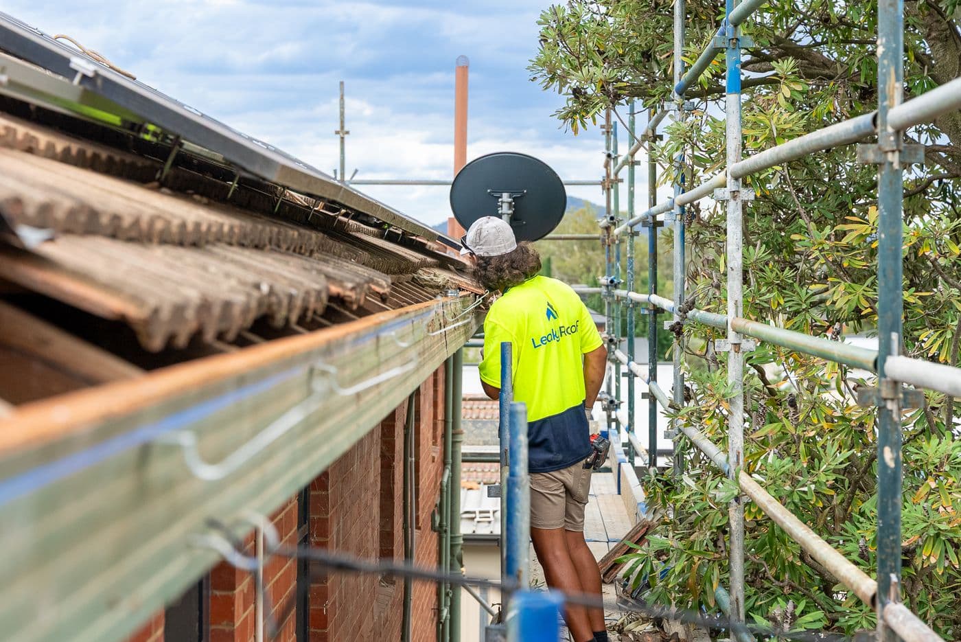 Looking along a tiled roof edge from the scaffold on a Leaky Roof job